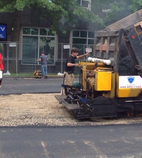 Crew patching asphalt at a commercial property in New Jersey