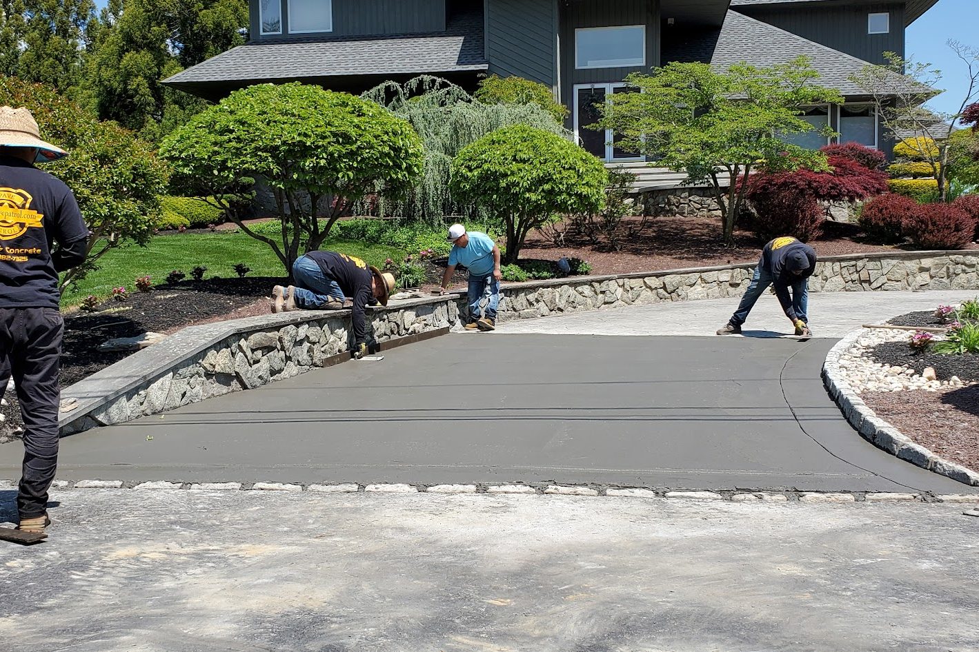 Pave Patrol crew finishing a new concrete driveway in New Jersey