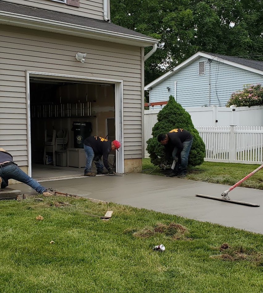 Concrete sidewalk being finished outside a New Jersey home