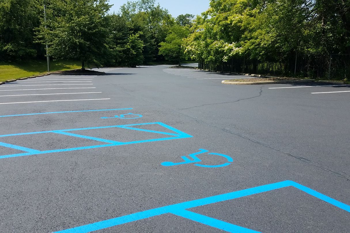 Fresh blue and white line striping on a New Jersey parking lot